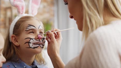 video of mom painting easter bunny on her daughter's face