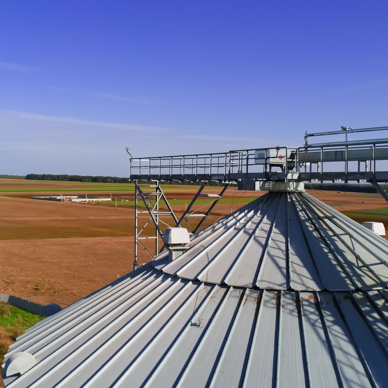 Aerial view. Metal grain elevator in agricultural zone. Grain warehouse