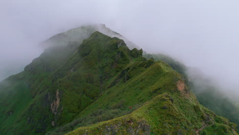 green hill ridge with clouds and fog cover, nepal's natural landscapes