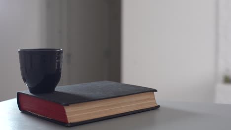 vintage old books on wooden deck tabletop against wall