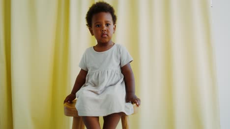 baby girl sitting on a chair