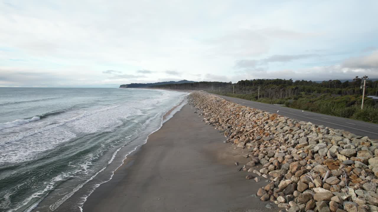 Rocky Sea Wall Between Maori Beach And Haast Highway On Bruce Bay In New Zealand. drone shot