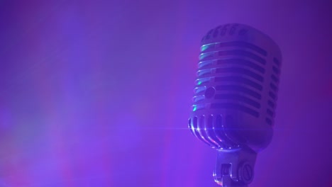 retro microphone with stage disco lights and fog. live performance or karaoke concept.