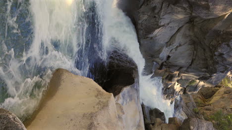 vertical - river rapids through boulders at god's bath swimming basin on clavey river in california