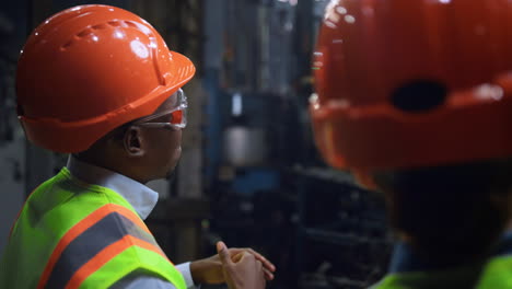 man professional moving hands near woman industrial engineer at facility.