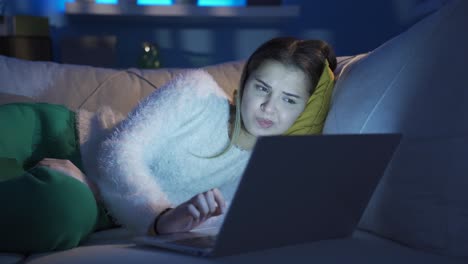 young woman using laptop at night.