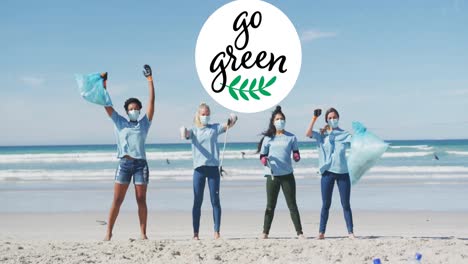 animation of go green text and logo over happy diverse group wearing face masks cleaning up beach