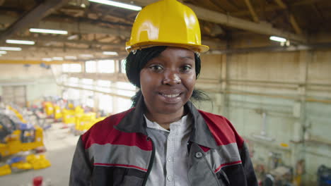 portrait of cheerful african american female worker in factory
