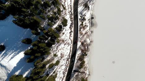 Aerial-Drone-View:-Snow-Covered-Bavarian-Alps-Mountain-Pass,-Cars-Driving-Scenic-Route-with-birds-eye-view-of-Winter-Wonderland-and-majestic-Landscape