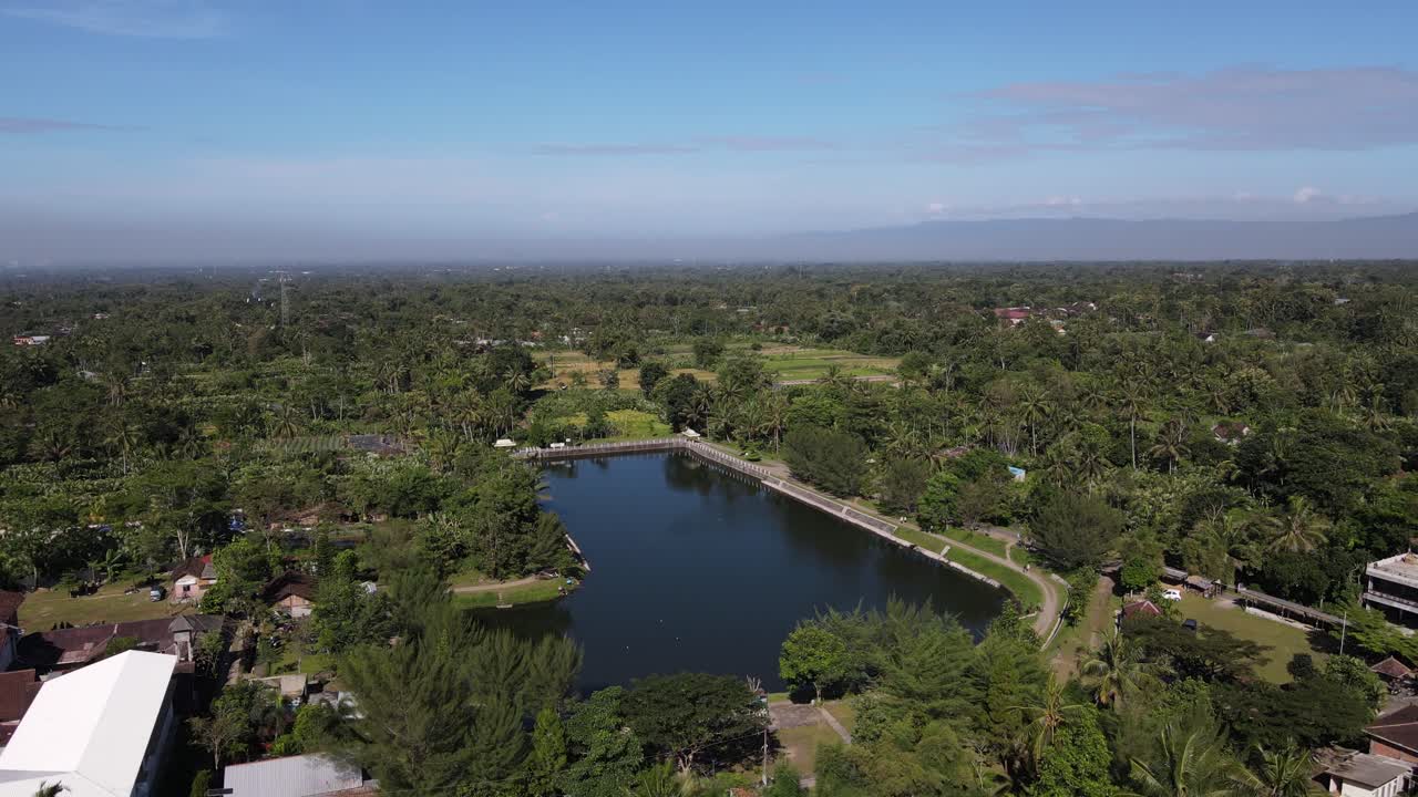 Beautiful aerial view of Kaliaji reservoir, a reservoir located in Turi, Sleman Regency, Yogyakarta. An attractive reservoir with a view of Mount Merapi in the background.