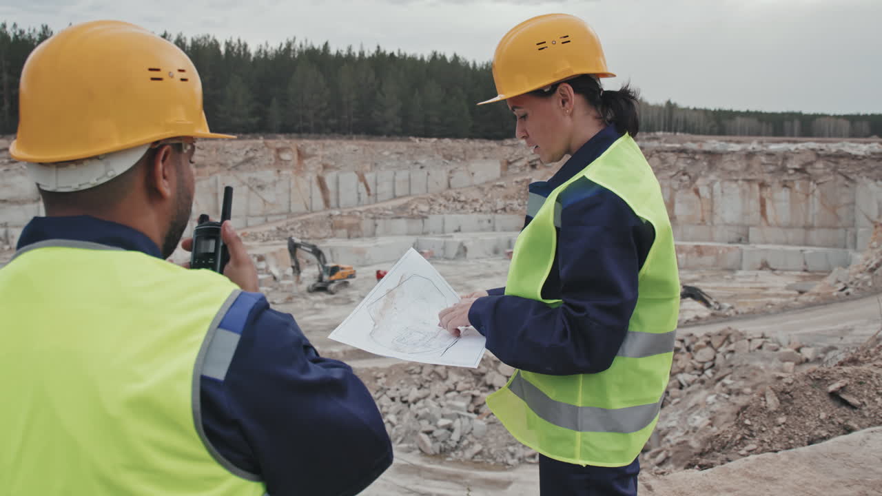 Supervisor Instructing Quarry Worker with Walkie-Talkie