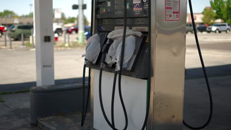 gas pumps at shut down fuel petrol station with plastic bags on all the nozzles due to gas shortage crisis and covid pandemic