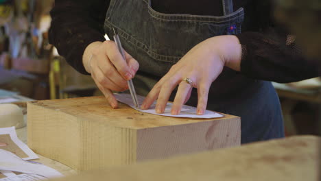 worker in bespoke shoemakers drawing template for last