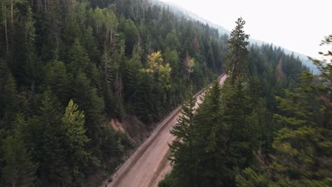 The-vast,-thick-forests-next-to-Adams-Lake,-British-Columbia-during-a-smoky-sunset