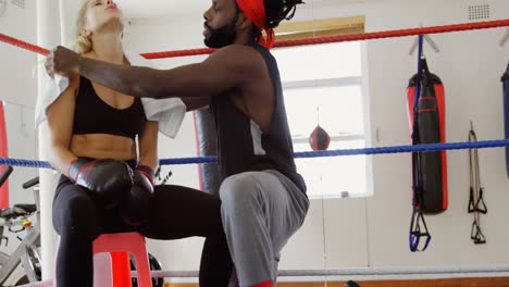 female boxer relaxing in boxing ring 4k