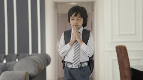 indian school boy praying to god