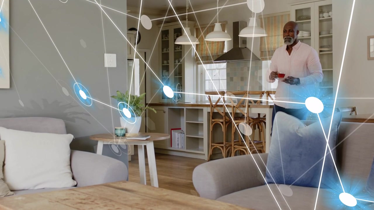 Senior man checking phone, activating tech overlay densifying as approaching table placing red cup