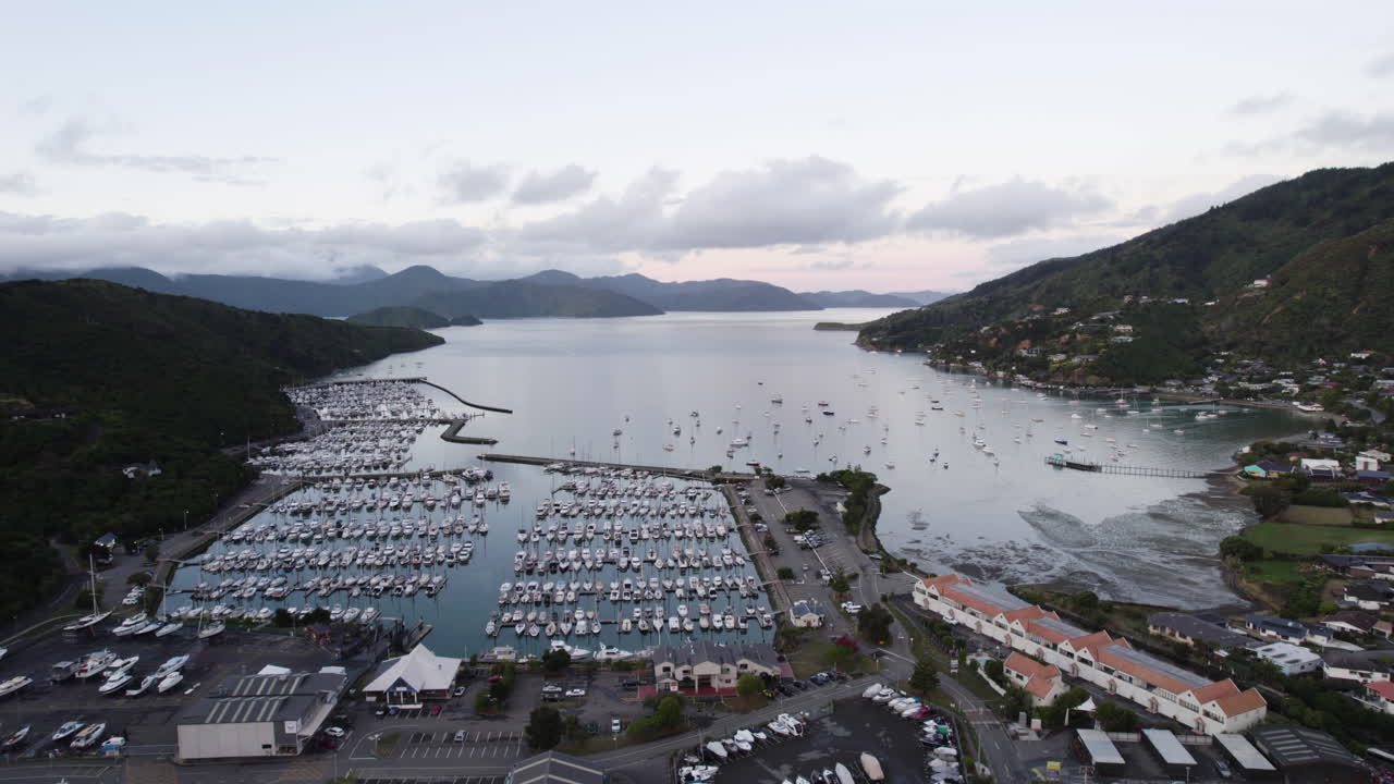 Drone shot backwards over of the Waikawa marina and village, dusk in New Zealand