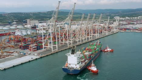 aerial view of a cargo container ship leaving the port