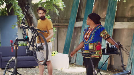 couple fixing bicycles home yard