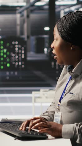 vertical video panicked system administrator in data center reacting to spyware warning