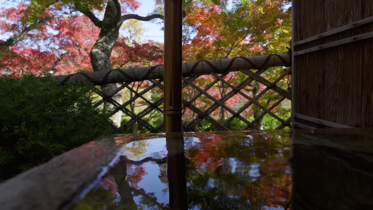 Perfect Japanese landscape garden with fall color reflections inside pond