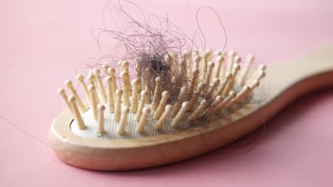 wooden hairbrush with lost hair