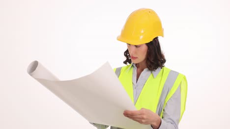 woman engineer examining blueprints