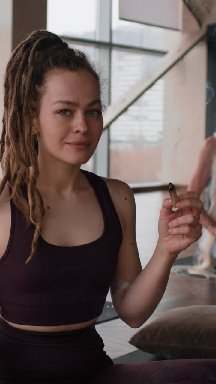 Woman practicing aromatherapy in yoga studio