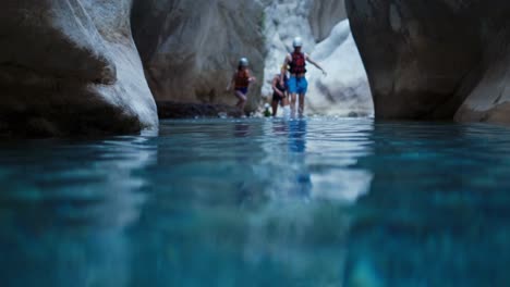 tourists are enjoying body rafting in mountain river flowing through a canyon