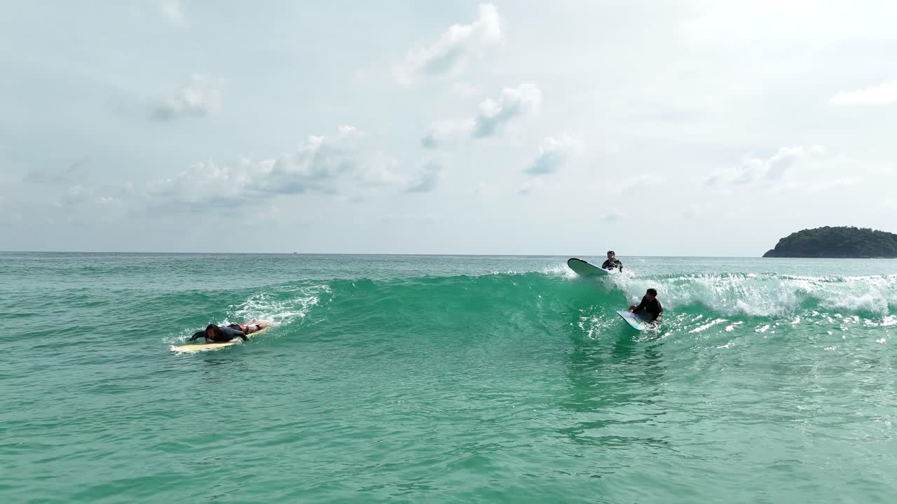 Surfers enjoying waves in a tropical ocean