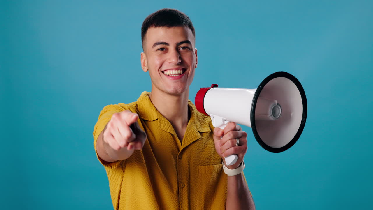 Man with megaphone pointing at the viewer