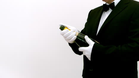 man opening a bottle of champagne