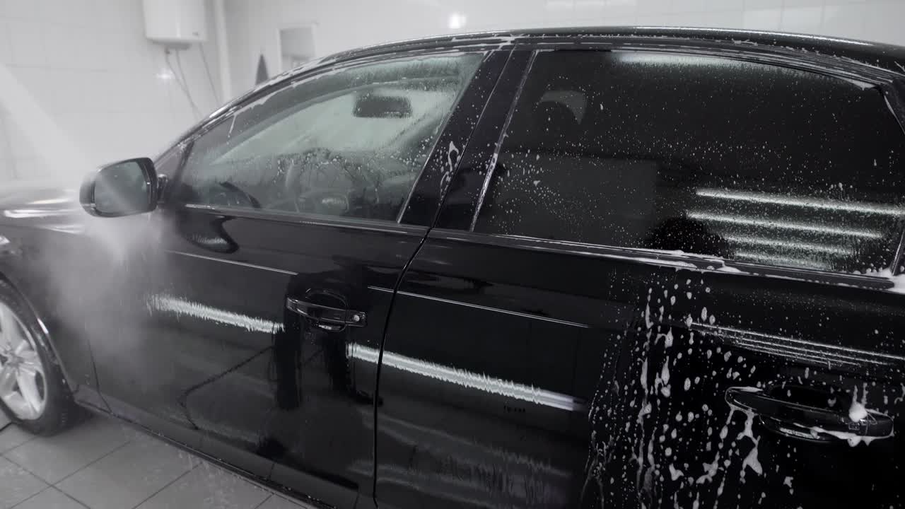 Black auto in car wash