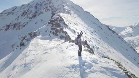 hiker on a snowy mountain summit