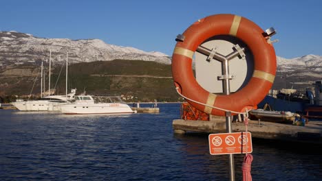 security post with lifebuoy and rope on the pier