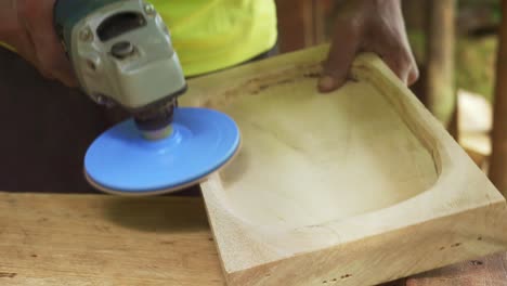 Carpenter-fine-finishing-wood-work-table-top-with-grinder