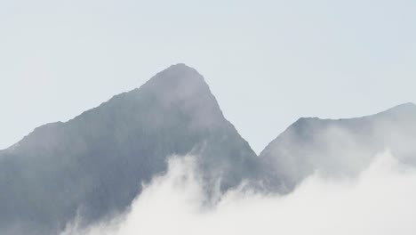 An-Amazing-View-of-Mountains-Veiled-in-Mist-in-Olaheimvatnet,-Senja,-Norway---Static-Shot