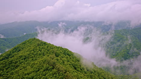 drone floats over the ghostly fog that hugs the smoky ridgelines