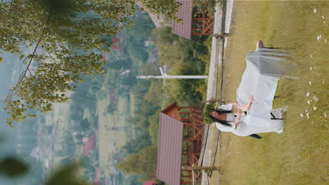 therapist female doctor making woman relaxing spa face massage outdoors in mountains field, fantasy