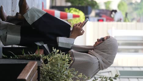 woman in hijab using a mobile phone outdoors