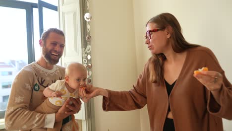 familia feliz alimentando al bebé