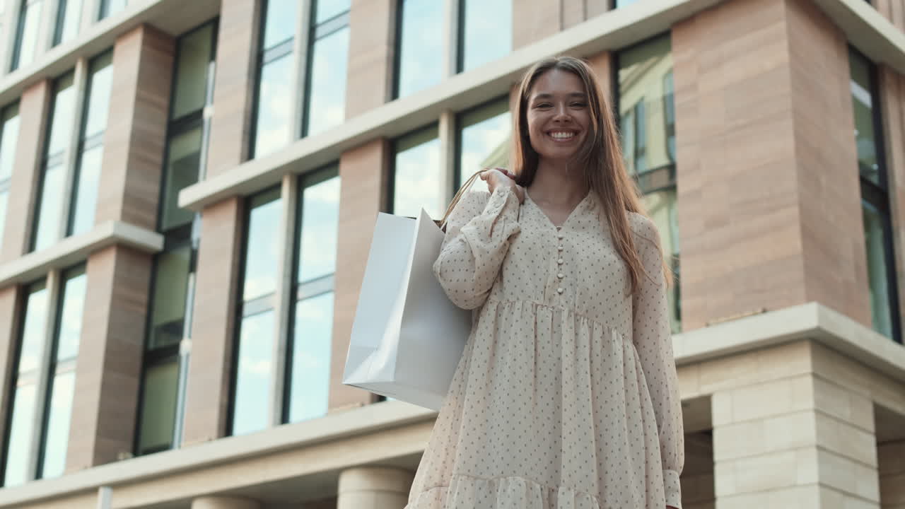 Woman Smiling Outdoors after Successful Shopping