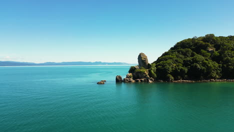 New-Zealand-rocky-coastline-with-vibrant-colors,-aerial-drone-view