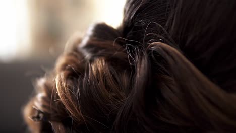 slow motion handheld shot of the brown hair of a pretty woman or bride celebrating her wedding day with her husband