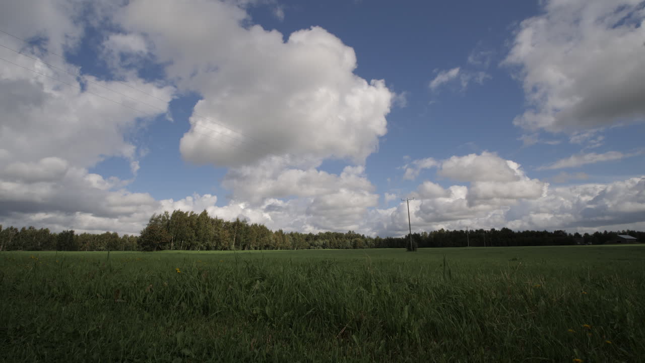 Big cloud casting shadow on open grass field, Wide country farmland landscape
