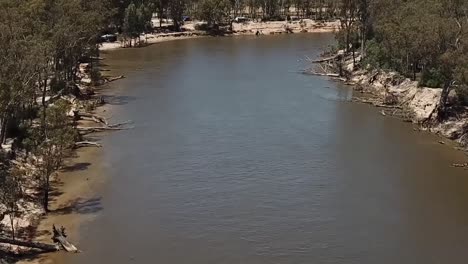 Outdoor-nature-drone-aerial-over-river-move-forward-pan-up-muddy-water