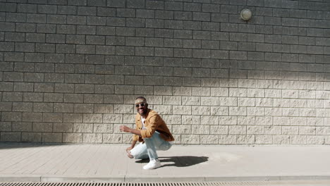 stylish man dancing outdoors