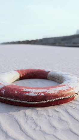 old life preserver on a sandy beach