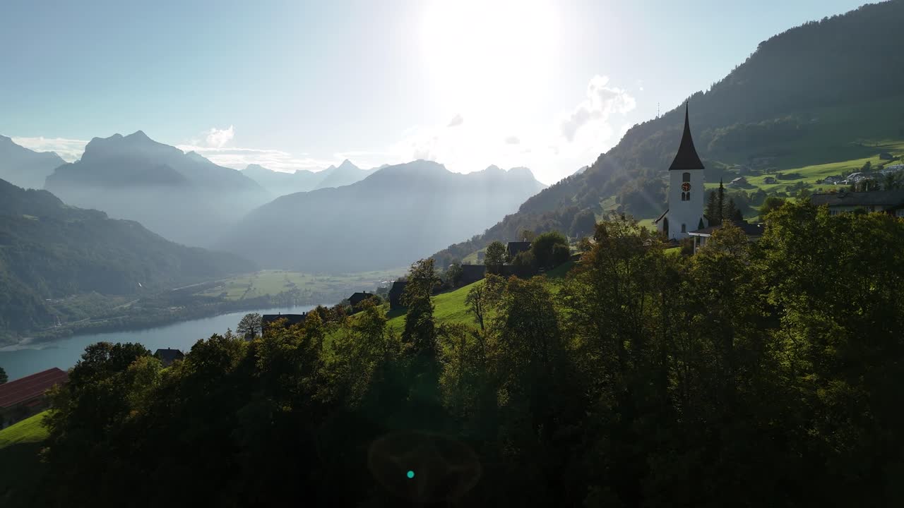 Stunning Aerial View of a Picturesque Alpine Village Nestled in the Swiss Mountains